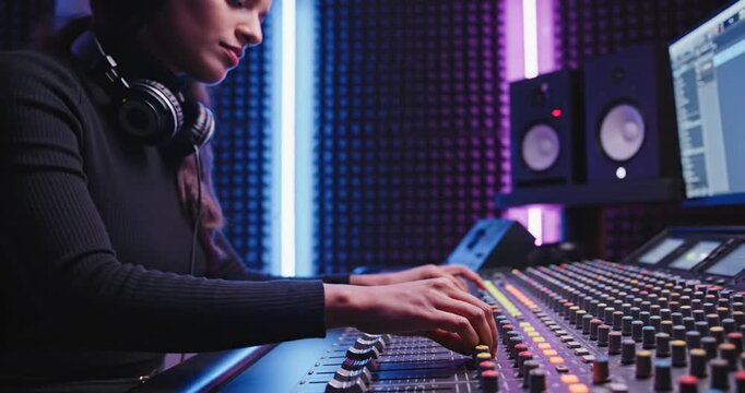 Music producer working on soundboard.