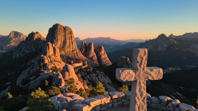 Two people at a stone cross on a mountain overlook pointing toward a distant monastery