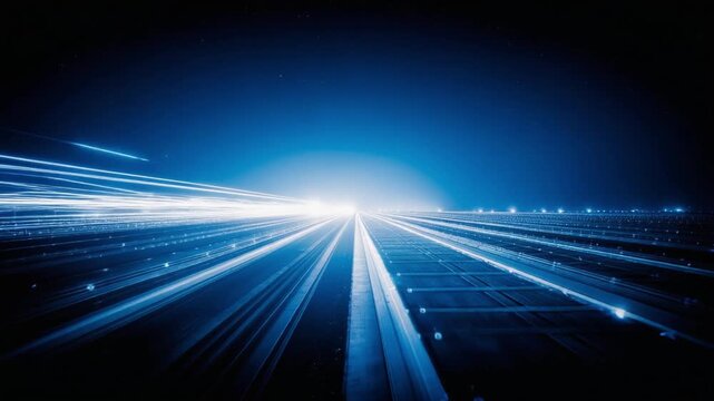 Abstract blue light trails creating a sense of speed and futuristic data flow on a dark background.