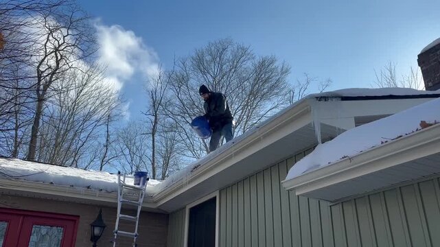  Man Pour Salt os Calcium Chloride over Frozen Gutters