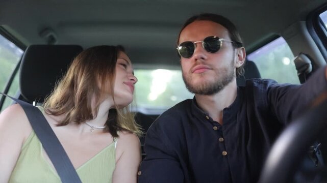 a couple in love are driving in a car and talking