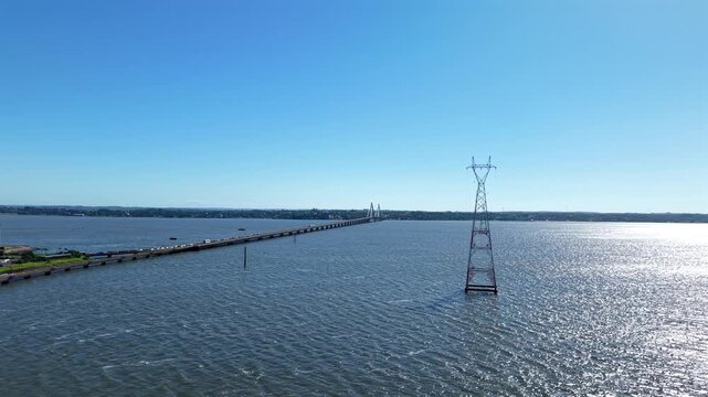 San Roque Gonz&aacute;lez de Santa Cruz International Bridge spanning the Paran&aacute; River between Posadas Argentina and Encarnaci&oacute;n Paraguay, showing long roadway traffic, and border infrastructure, aerial