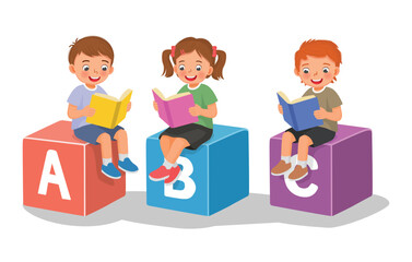 Obraz premium children reading books sitting on big alphabet block cubes