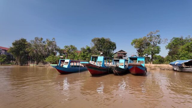 Cruising past boats near the floating village of Kampong Phluk in Cambodia.
