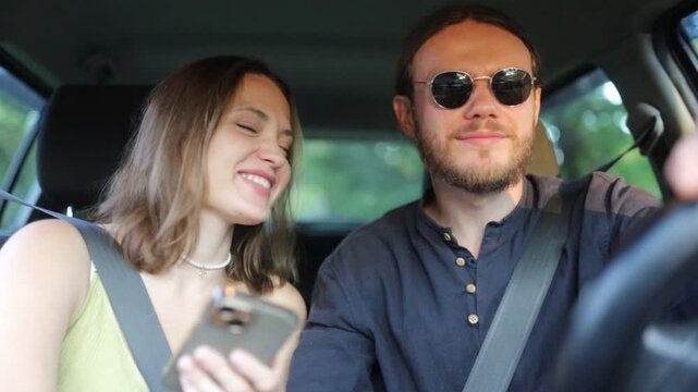 a couple in love are driving in a car and talking