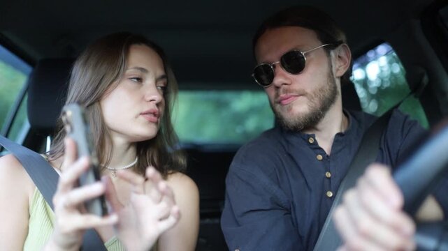 a couple in love are driving in a car and talking