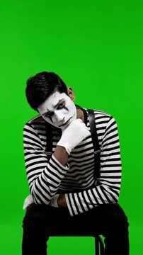 Sad Mime Artist Looking Down Dejectedly on Green Screen - Vertical Emotional Portrait
