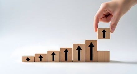 Hand adds final block to upward trend graph on white table