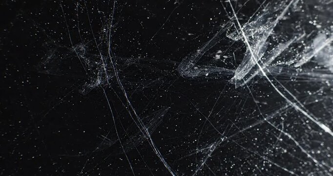 Scratches on dark surface closeup.