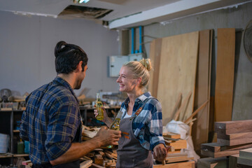 Carpenters are working together at workshop.