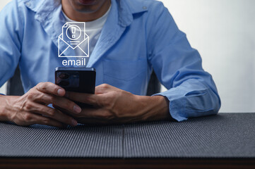Man Using Smartphone to Check Email Notifications at Workplace