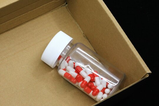 Medication pill bottle in an open shipping package