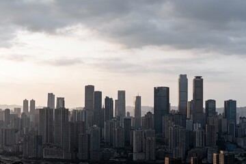 Fototapeta premium City skyline with tall buildings under cloudy sky