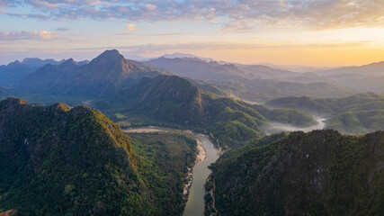 The breathtaking natural landscape features rolling mountains interspersed with rivers and lush forests of Thailand.