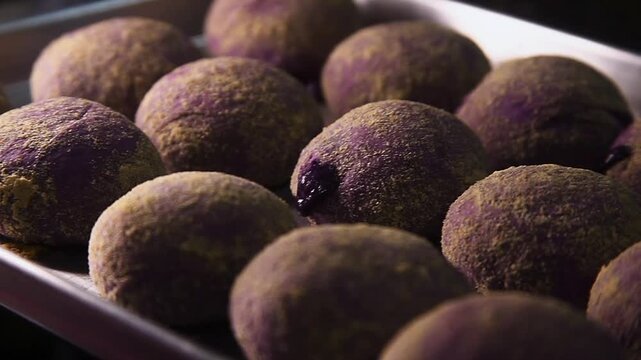 Freshly baked Filipino food called Ube Cheese Pandesal or Bread with yam jam and cheese filling.