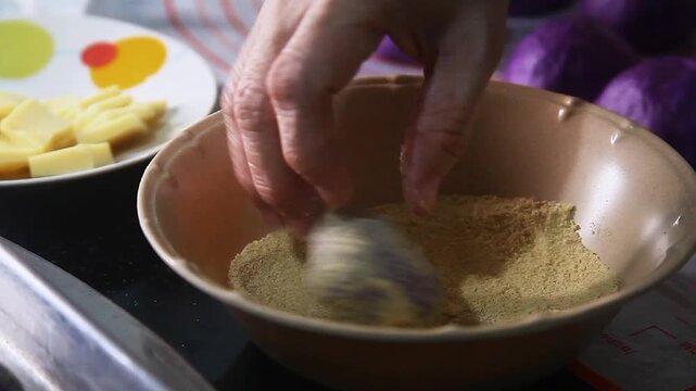 Filipino food called Ube cheese pandesal or bread with yam jam and cheese filling being prepared to be baked.
