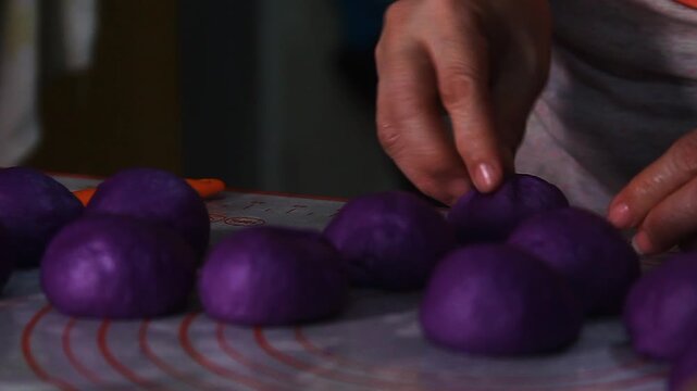 Filipino food called Ube cheese pandesal or bread with yam jam and cheese filling being prepared to be baked.