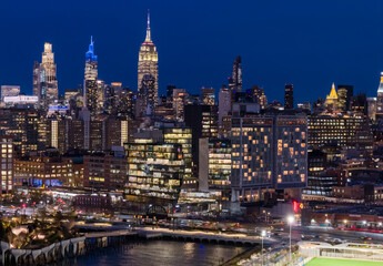 New York night metropolis. NYC skyscrapers at night. NewYork City downtown at night. Lower Manhattan skyline. New York landscape. New York big American City. New York cityscape waterfront.