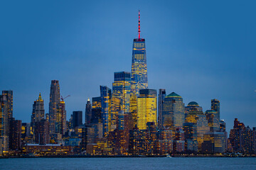 Obraz premium New York City skyline. New York City riverfront at night . New York City night scene. New York City skyscrapers with night lights.