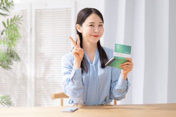 通帳を持つ女性