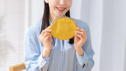 笑顔で財布を持つ女性