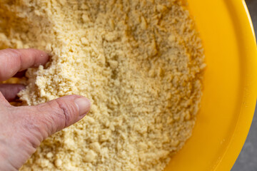 Preparing vanilla crescent cookies &ndash; rubbing butter into flour in mixing bowl