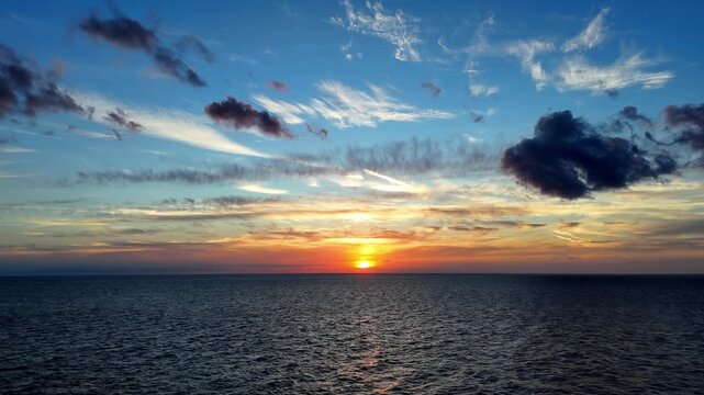 Spectacular Malta Sunset Over Mediterranean Sea During Golden Hour in Summer with Dramatic Orange and Blue Clouds Captured from a Wide Angle Perspective Showcasing the Natural Beauty of Gozo and Comi