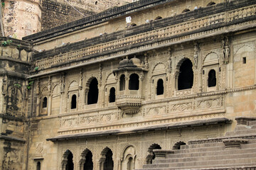 Naklejka premium Indian Temple Architecture at Maheshwar Showcasing Murals and Sculptures