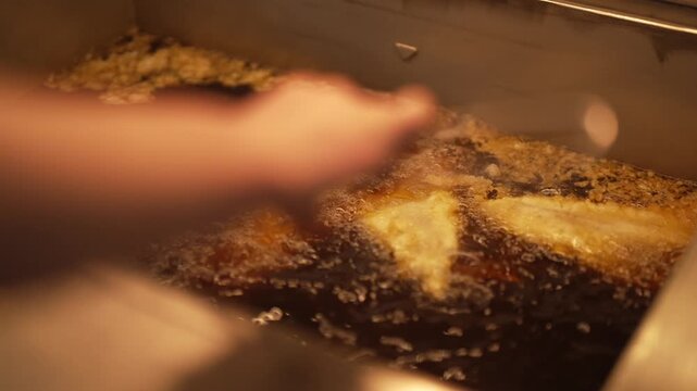 Traditional British fish frying in a commercial fryer