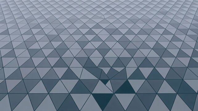 Geometric pattern of triangles in shades of gray creating an abstract background with metallic sheen