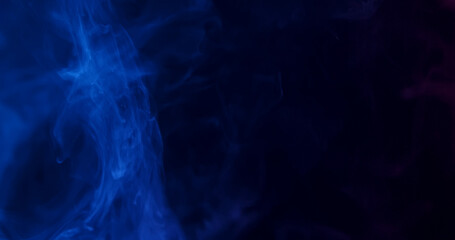 Ethereal blue smoke swirls elegantly against a dark background, creating a mysterious and atmospheric scene.