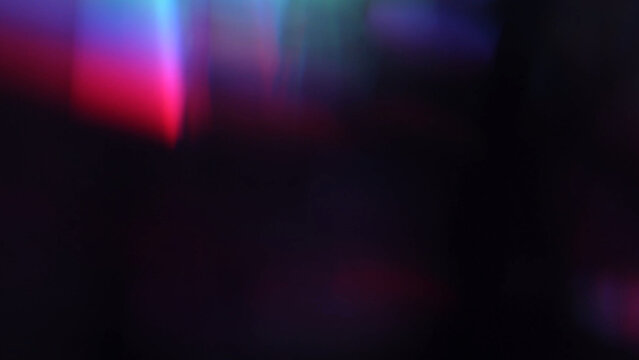 Blur colorful rainbow crystal light leaks on black background. Defocused abstract multicolored retro film lens flare bokeh analog photo overlay or screen filter effect. Glow Vintage prism colors