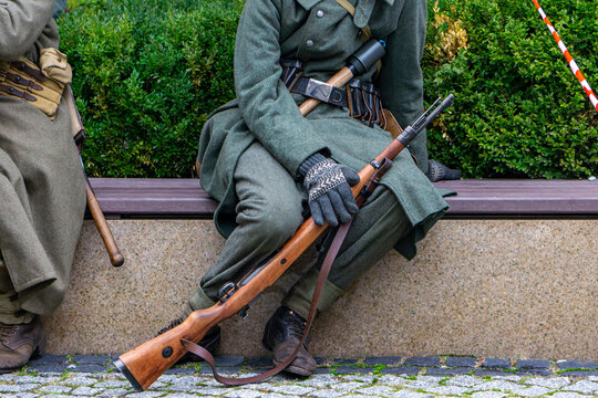 German soldier with Mauser K98 rifle and stick grenade, Wehrmacht historical reenactment, details of winter infantry uniform and WW2 military equipment, authentic historical reconstruction.