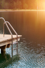 Fototapeta premium Old wooden pier with metal ladder detail