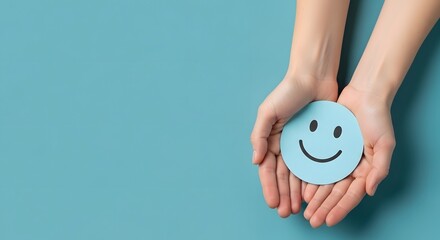 Hands Holding a Blue Smiley Face on Teal Background