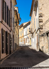 Obraz premium Narrow street in historic Arta, Mallorca, lined with traditional stone houses. Perfect Mediterranean travel destination and European architecture concept.