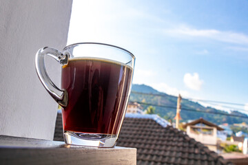 Fototapeta premium Black coffee with tropical landscape terrace balcony panorama view Thailand.