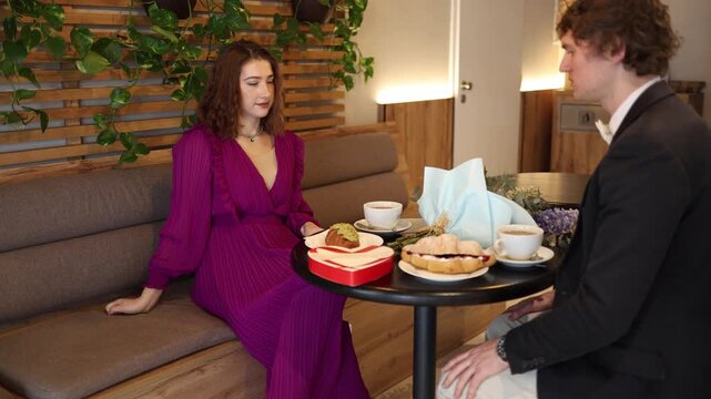 Man stands up and leaves cafe date after awkward conversation showing disappointment emotional distance and lack of connection while woman stays seated confused and silent