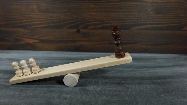 Democracy And Majority Power Tension Illustrated With Chess Figures On Wooden Balance