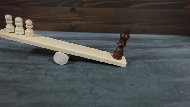Power Dominance And Social Inequality Illustrated With Chess Figures On Wooden Balance