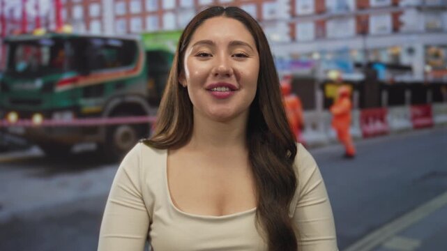 Young hispanic woman shouting with cupped hands to mouth in front of building under construction; enthusiasm.