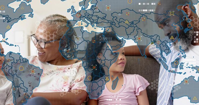 Sitting family members talking on gray sofa at home, wearing glasses, with data map overlay