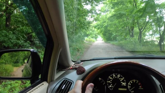 inside the car. driver behind the wheel. drive a car. journey. bad roads. by car . steering wheel and dashboard. wheels and engine.