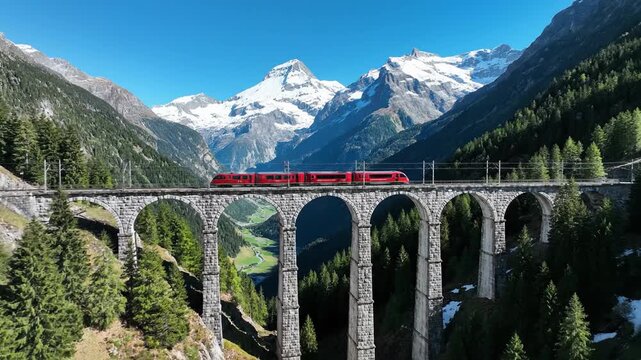 Scenic Train Journey Across a Stone Bridge in the Swiss Alps.