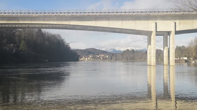 Motorway bridge over river with Alps in the distance, Ticino river and Sesto Calende, northern Italy