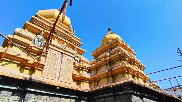 Kodangal Sri Mahalakshmi Venkateshwara Swamy main shikhara or vimana Temple architecture with blue sky. day time, stable shot, low angle shot, 4k.