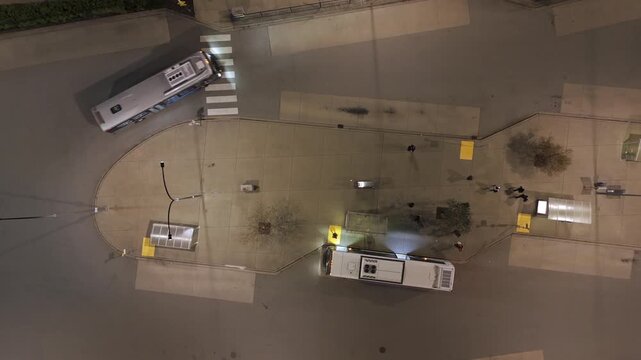 Bus Drives Around Carvolth Exchange Transit with Passengers at Platform - Aerial Vertical Top Down at Night