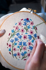 Close-up of a woman&rsquo;s hands stitching with embroidery thread. The image captures the creative process of hand embroidery, perfect for DIY crafts, needlework, and artistic hobbies.