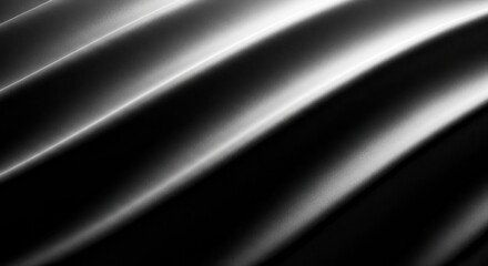 Obraz premium Abstract black wavy texture background with dramatic highlights and shadows