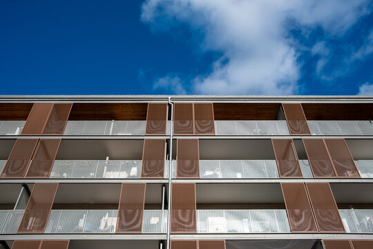 Modern apartments architecture building facade shows windows lines in minimal composition with sky and ample copyspace for print design